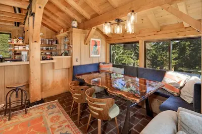a living room with a table and a couch at Amazing Architecture - Views all around VH#113 in Tamarack