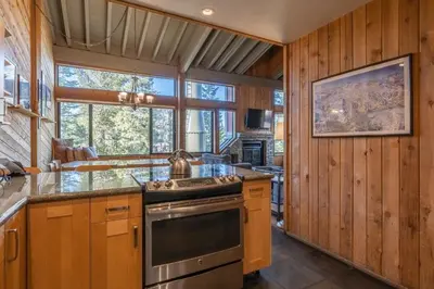 a kitchen with wooden walls and a large window at Updated 5 Bedroom 3 bathroom townhome Slopeside at 1849 Condos 671 sleeps 10 in Mammoth Lakes