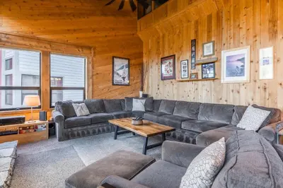 a living room with a couch and a table at Updated 5 Bedroom 3 bathroom townhome Slopeside at 1849 Condos 671 sleeps 10 in Mammoth Lakes