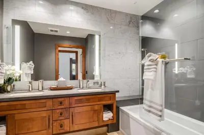 a bathroom with a sink and a tub and a mirror at Ultimate Luxury Residence with Extras Galore across from Heavenly Village & Gondola - Zalanta Resort in South Lake Tahoe