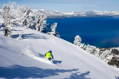 a person is skiing down a snow covered slope at Ultimate Luxury Residence with Extras Galore across from Heavenly Village & Gondola - Zalanta Resort in South Lake Tahoe