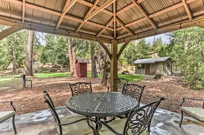 a table and chairs on a patio with a gazebo at Rustic Oakhurst Retreat Less Than 4 Mi to Bass Lake! in Oakhurst