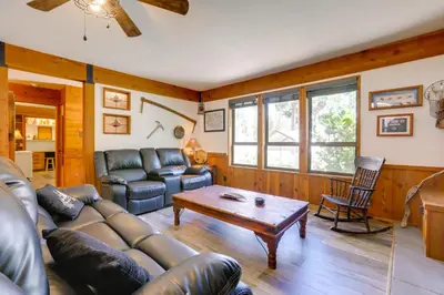 a living room with a couch and a table at 1 Mi to Lake Hot Tub Haven in Pollock Pines! in Pollock Pines