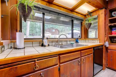 a kitchen with a sink and a window at 1 Mi to Lake Hot Tub Haven in Pollock Pines! in Pollock Pines