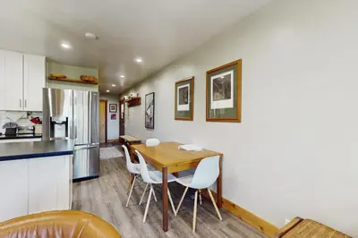 a kitchen and dining room with a wooden table and chairs at Coyote Fork Escape in Truckee