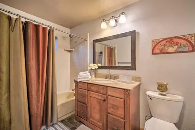 a bathroom with a toilet and a sink and a mirror at Deck and Grill Mtn Haven in Stanislaus Natl Forest in Arnold