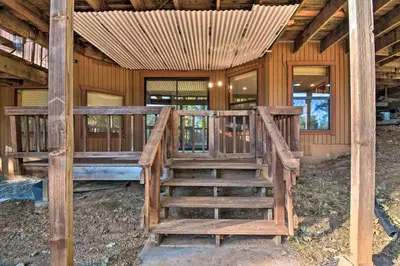 a wooden house with a staircase in front of it at Deck and Grill Mtn Haven in Stanislaus Natl Forest in Arnold
