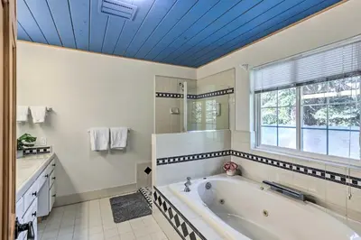 a bathroom with a tub and a window at 6 Mi to Homewood Mountain Resort Tahoe City Gem! in Tahoe City