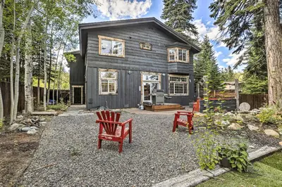 a black house with two red chairs in front of it at 6 Mi to Homewood Mountain Resort Tahoe City Gem! in Tahoe City