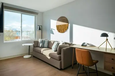 a living room with a couch and a desk at Element Reno Experience District in Reno