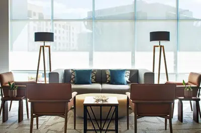 a living room with a couch and two chairs at Element Reno Experience District in Reno