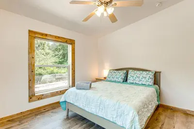 a bedroom with a bed with a ceiling fan and a window at 33 Mi to Yosemite Secluded Mariposa Retreat! in Mariposa