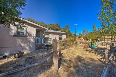 a house with a fence in front of it at 33 Mi to Yosemite Secluded Mariposa Retreat! in Mariposa