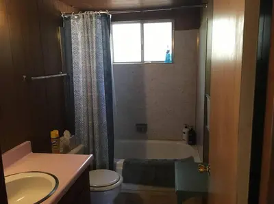 a bathroom with a tub and a toilet and a sink at Lakeside BLS Retreat near Big Trees & Bear Valley in Arnold
