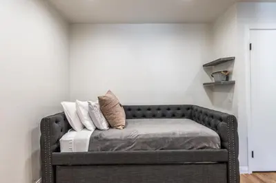 a couch with pillows on it in a room at Highly updated 1 Bedroom plus den, 2 bath Crestview Unit 5 Sleeps up to 4 located near Canyon Lodge in Mammoth Lakes