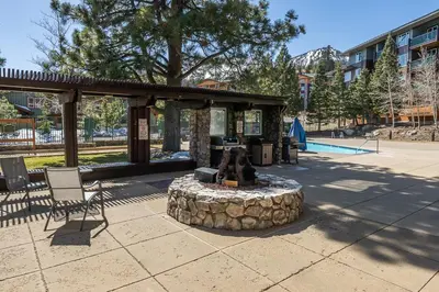 a fire pit in a park with a bench and a bench at Ski in Ski Out Juniper Springs Lodge #351 Luxury Slope-side 2 Bedrm 2 Bath End Unit! in Mammoth Lakes