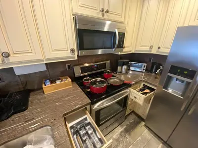 a kitchen with a stove with pots and pans on it at Historic Washington St Balcony in Sonora