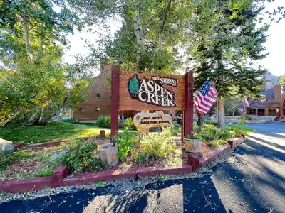 a sign for a sign for a inn on a street at Aspen Creek #115 condo in Mammoth Lakes