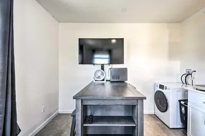 a small kitchen with a washer and dryer at Contemporary Los Banos Studio Less Than 3 Mi to Dtwn! in Los Banos