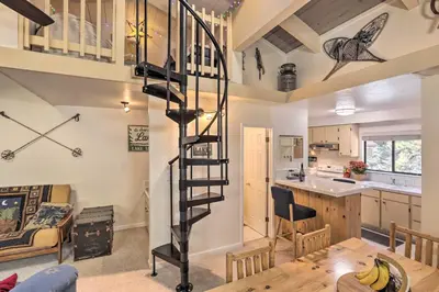 a living room with a spiral staircase in a house at 1 Mi to Diamond Peak Skiing Incline Village Condo in Incline Village