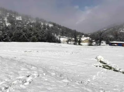 a snow covered field with a house in the background at Waxberry Getaway Sequoia/Kings Canyon National Pks in Squaw Valley
