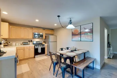 a kitchen and dining room with a table and chairs at 12 Mi to Apple Hill Family-Friendly Cabin Retreat in Pollock Pines