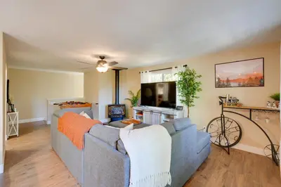 a living room with a couch and a tv at 12 Mi to Apple Hill Family-Friendly Cabin Retreat in Pollock Pines
