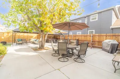a patio with a table and chairs and an umbrella at Rustic 2-Bedroom walking distance to Downtown in Reno