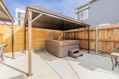 a barbecue under an umbrella on a patio at Rustic 2-Bedroom walking distance to Downtown in Reno