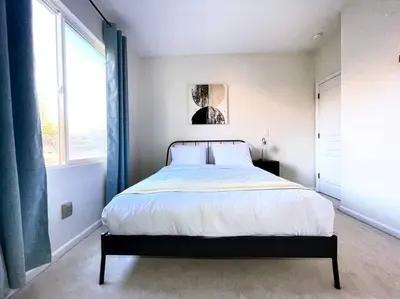 a bedroom with a bed and a large window at King Bed Quiet Home on Cul-de-Sac Hiking Trails in Roseville