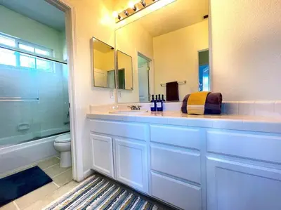a bathroom with a sink and a toilet and a mirror at King Bed Quiet Home on Cul-de-Sac Hiking Trails in Roseville