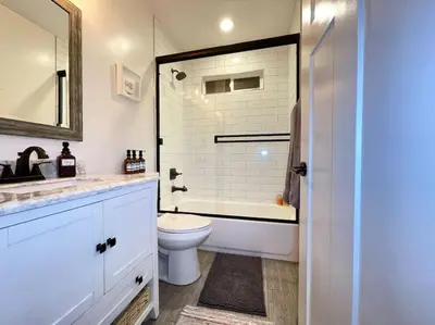 a bathroom with a toilet and a tub and a sink at King Bed-Private Yard-Driveway Parking in Sacramento