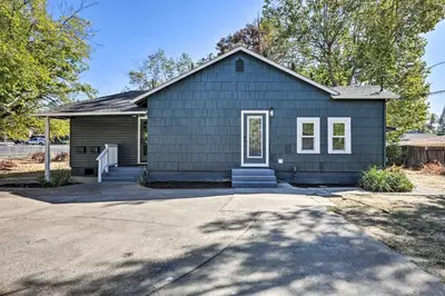 a small blue house with a driveway at Boho-Chic Folsom Retreat Walkable Location! in Folsom