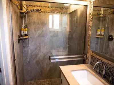 a bathroom with a shower and a sink at Pool! Quite, Private, remodeled home on the hill in Placerville
