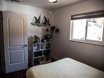 a bedroom with a bed and a window and a windowpectpect at Pool! Quite, Private, remodeled home on the hill in Placerville