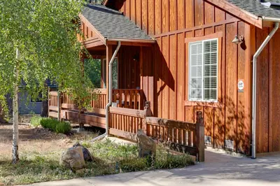 a wooden cabin with a porch on the side of it at Near Hikes Arnold Cabin with EV Charger and Fire Pit in Arnold