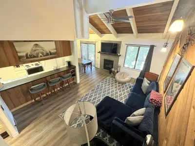 a living room with a blue couch and a kitchen at 118 Standard home in Mammoth Lakes