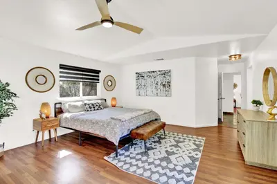 a bedroom with a bed and a ceiling fan at Villa near Yosemite & bass lake w/Hot Tub/EVcharge in Oakhurst