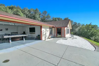 a home with a patio and a pool table at Villa near Yosemite & bass lake w/Hot Tub/EVcharge in Oakhurst