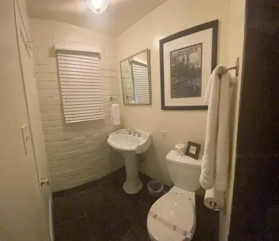 a bathroom with a white toilet and a sink at Sierra Woods Lodge in Emigrant Gap