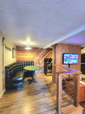 a living room with a table and a couch at Bear Cave- Pet Friendly Suite in Shaver Lake in Shaver Lake