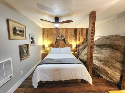 a bedroom with a bed and a ceiling fan at Bear Cave- Pet Friendly Suite in Shaver Lake in Shaver Lake