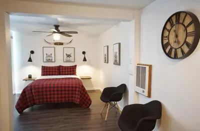 a bedroom with a bed and a clock on the wall at Fox Den- Pet Friendly Suite in Shaver Lake in Shaver Lake
