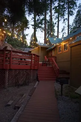 a house with a red fence and a walkway at Fox Den- Pet Friendly Suite in Shaver Lake in Shaver Lake