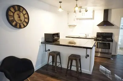 a kitchen with a counter and a clock on the wall at Fox Den- Pet Friendly Suite in Shaver Lake in Shaver Lake