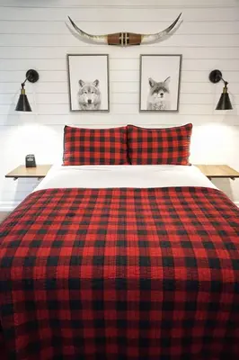 a red and black plaid blanket on a bed at Fox Den- Pet Friendly Suite in Shaver Lake in Shaver Lake