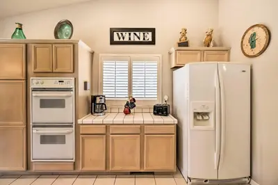 a kitchen with a white refrigerator freezer next to a window at Hot Tub and Fire Pit Reno Gem 12 Mi to Skiing in Reno