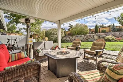 a patio with chairs and a table with a white umbrella at Hot Tub and Fire Pit Reno Gem 12 Mi to Skiing in Reno