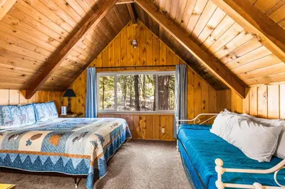 a bedroom with two beds and a window in a cabin at Jug Handle Hideaway in Arnold