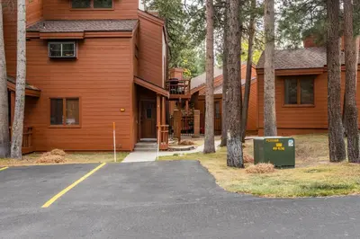 a house with a parking lot in front of it at Updated 2 Bedroom and Loft 2 Full Bathroom Woodlands #51Just Steps to Shuttle Close to Golf Course in Mammoth Lakes